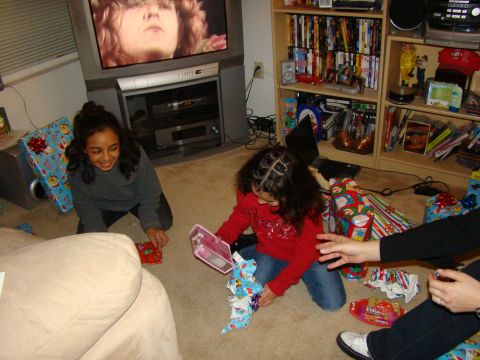 1989 Ford Bronco - Children excitedly open gifts on Christmas morning in front of a television.