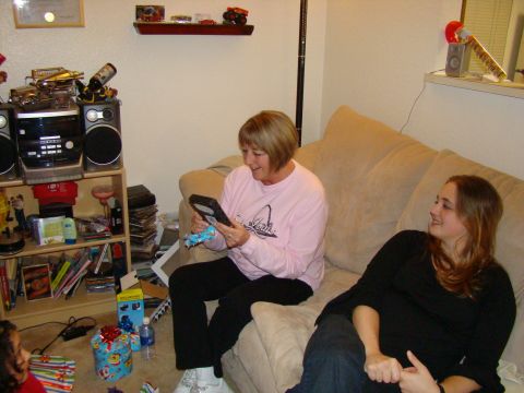 1989 Ford Bronco - Two women are sitting on a couch in a living room, surrounded by Christmas gifts and decorations.