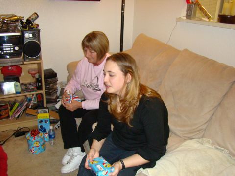 1989 Ford Bronco - Two women are sitting on a couch, surrounded by gifts, suggesting a holiday gathering.