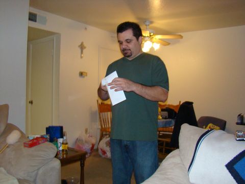 1989 Ford Bronco - A man stands in a living room, looking down at a piece of paper he is holding.