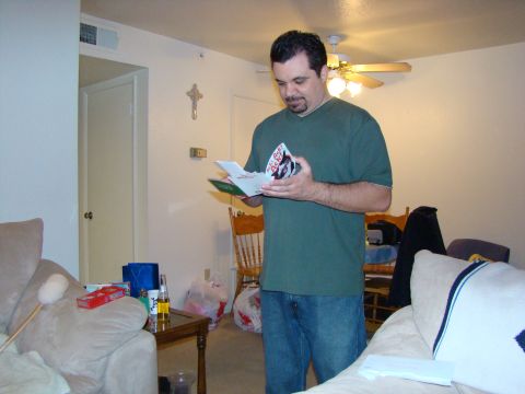 1989 Ford Bronco - A man stands in a living room, looking at a card he is holding.