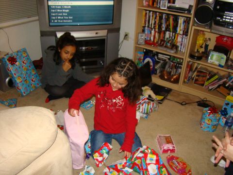 1989 Ford Bronco - Children excitedly open gifts on the floor, surrounded by wrapping paper and holiday decorations.