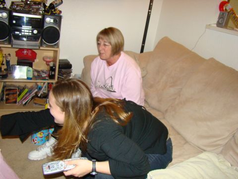 1989 Ford Bronco - Two women are in a living room, one holding a remote control and the other sitting on a couch.