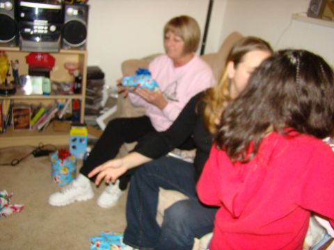 1989 Ford Bronco - People gathered indoors, opening presents during a holiday celebration.