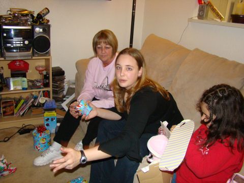 1989 Ford Bronco - A family gathers on a couch, surrounded by presents, during a holiday celebration.