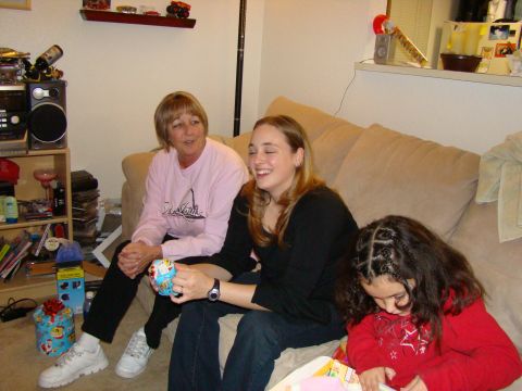 1989 Ford Bronco - Two women and a girl are sitting together on a couch in a living room.