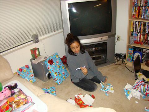 1989 Ford Bronco - A young woman sits on the floor surrounded by opened and unopened Christmas gifts.