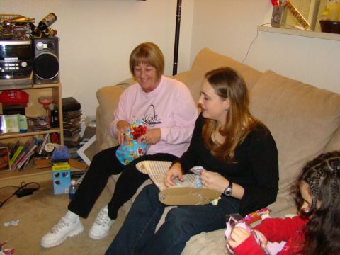 1989 Ford Bronco - Three people are gathered on a couch, opening gifts during what appears to be a holiday celebration.