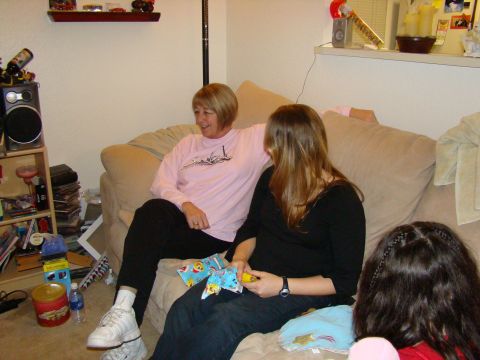 1989 Ford Bronco - A casual indoor scene with people gathered on a couch, possibly during a gift-giving occasion.