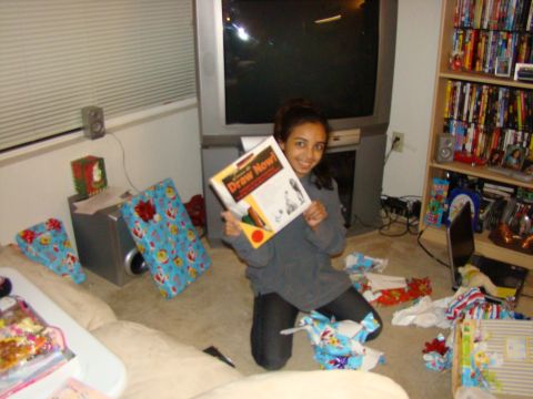 1989 Ford Bronco - A young girl proudly displays a book in a room filled with Christmas presents and entertainment systems.