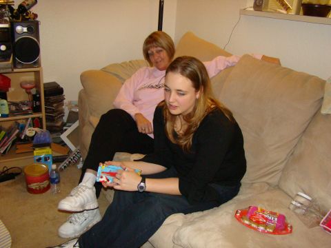 1989 Ford Bronco - Two women relax on a couch, with one examining a small toy.