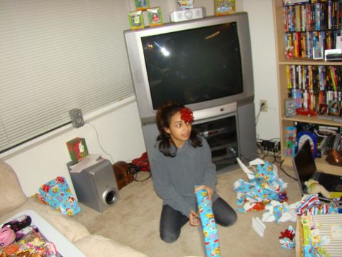 1989 Ford Bronco - A young woman sits amidst discarded wrapping paper and gifts in a living room.