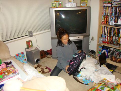 1989 Ford Bronco - A young girl unpacks a gift in a room filled with holiday decorations and entertainment items.