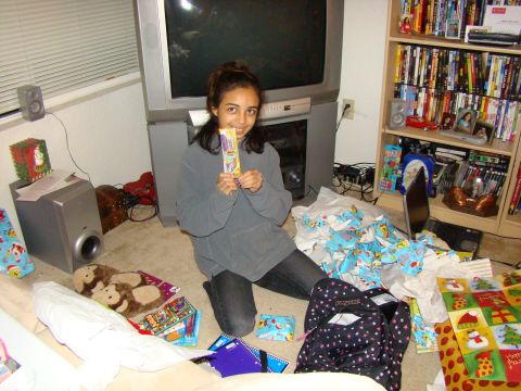 1989 Ford Bronco - A young person sits on the floor amidst wrapping paper and gifts, holding a treat.