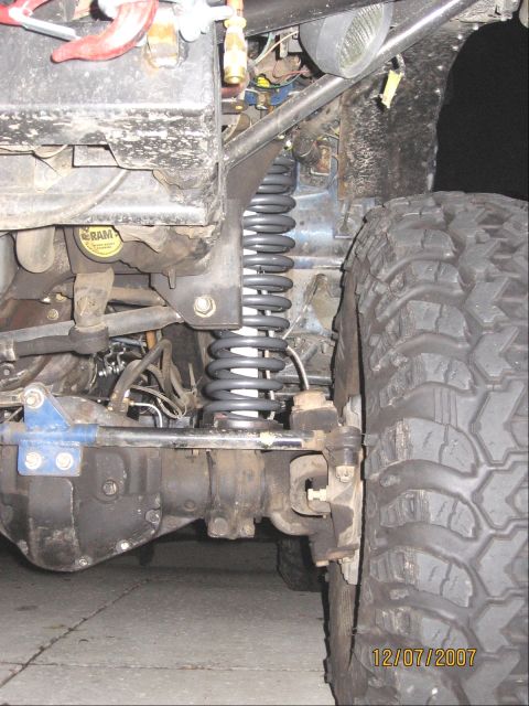 1994 Ford Bronco - The image shows a close-up view of the suspension system and tire of an off-road vehicle.