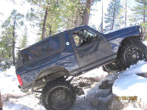 1994 Ford Bronco - 1994 Ford Bronco navigating snowy terrain, with "BRONCO" visible on the fender.