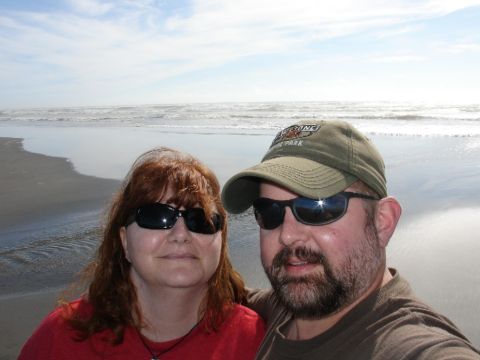 1978 Ford Bronco - A couple enjoys a day at the beach with waves crashing in the background.