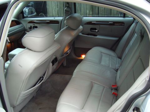 2002 Lincoln Town Car - Interior of a 2002 Lincoln Town Car, light-colored leather seats and wood accents.
