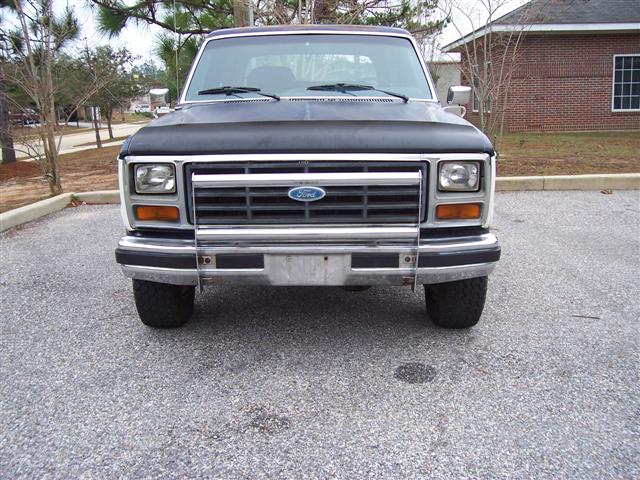 Front view of a 1980s Ford truck with a chrome grille and Ford emblem