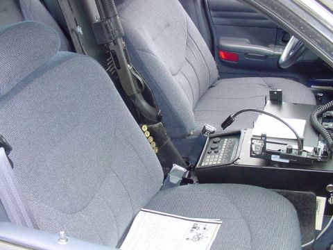 2001 Ford Crown Victoria - Interior view of a 2001 Ford Crown Victoria, equipped with a shotgun and police radio.