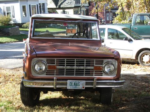 1995 Ford Bronco - This classic Ford Bronco, likely from the mid-1970s, is parked in front of other vehicles on a sunny day.