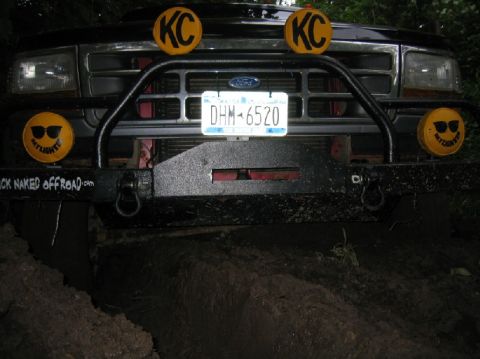1995 Ford Bronco - This Ford truck's front end is equipped with KC lights and a custom bumper with off-road branding.