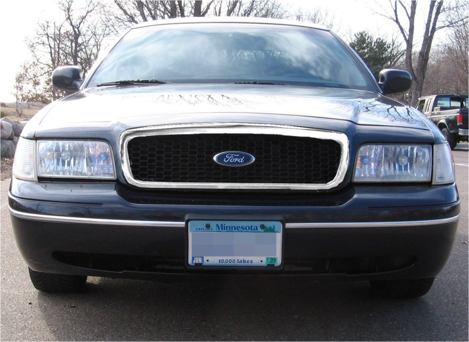 Black Ford Crown Victoria front view, honeycomb grille, Minnesota license plate
