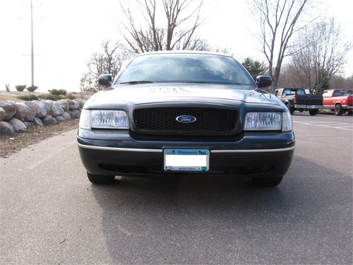 Front view of a 1998 Ford Crown Victoria grille with a Minnesota license plate