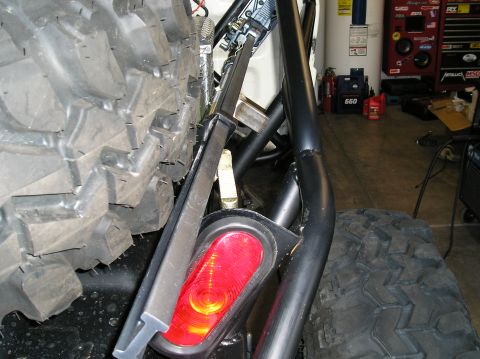 1986 Toyota Hilux - Close-up of a spare tire and taillight assembly on a vehicle with a roll cage.