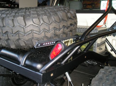 1986 Toyota Hilux - Close-up view of a spare tire and custom roll cage mounted in the bed of a truck.