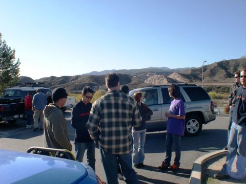 2007 Toyota FJ Cruiser - A group of people stand around a silver SUV in a scenic, mountainous area.
