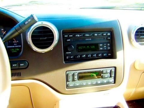 2003 Ford Expedition - The interior dashboard of a 2003 Ford Expedition features a radio, climate controls, and air vents.