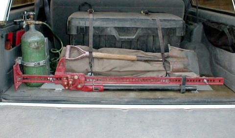 1996 Ford Bronco - Cargo area of a 1996 Ford Bronco contains a Hi-Lift jack, shovel, toolbox, and propane tank.