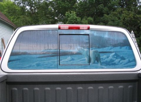 2003 Ford F-150 - Rear window of a truck features a decal of a polar bear in an icy landscape, with a sliding window in the center.