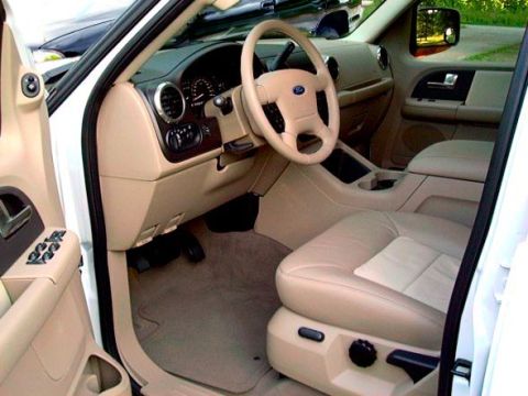 2003 Ford Expedition - The interior of a 2003 Ford Expedition features tan leather seats and a beige dashboard.
