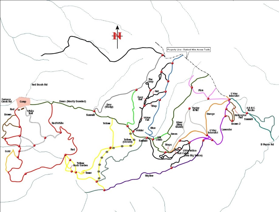 Color-coded off-road trail system map with named routes and a north arrow
