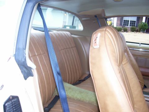 1979 Chevrolet Camaro - Interior view of a 1979 Chevrolet Camaro, showing tan seats and blue seatbelts.