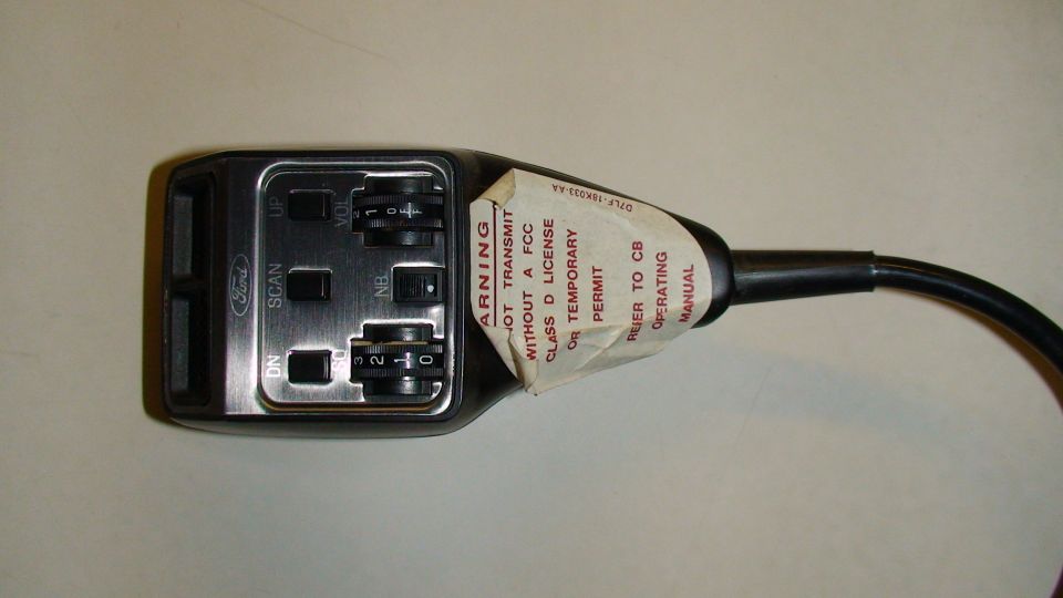 Ford CB radio microphone with "Ford" logo, scan and volume knobs, and warning sticker