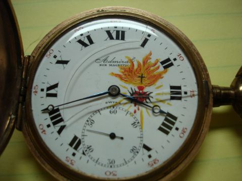 1994 Ford Bronco - Pocket watch face displays Roman numerals, a sub-dial, and religious imagery.