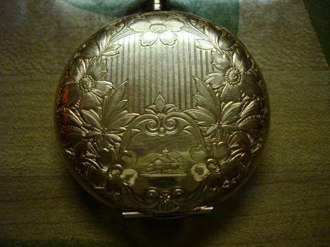 1994 Ford Bronco - This ornate pocket watch features intricate floral engravings and a detailed landscape scene on its cover.