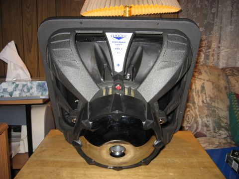 1992 Ford Crown Victoria - A Kicker Solo-Baric subwoofer is shown from its rear, with visible branding and mounting points.
