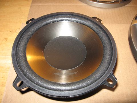 1992 Ford Crown Victoria - A close-up view of a car speaker with a metallic cone and black surround. Text is visible on the cone.