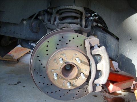 2005 Ford Crown Victoria - This photo shows a close-up of a vehicle's front brake system, including the rotor and caliper.