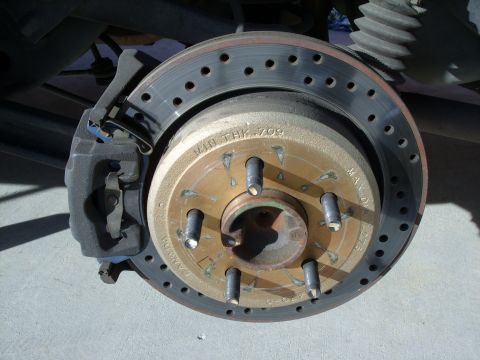 2005 Ford Crown Victoria - Close-up view of a vehicle's rear brake assembly, showing the rotor and caliper.