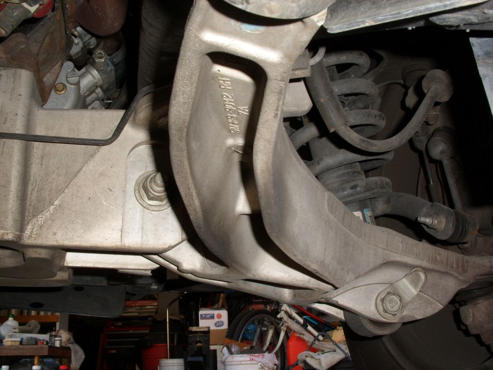 Aluminum front subframe cradle stamped 3W23-3082 RH with coil spring strut alongside