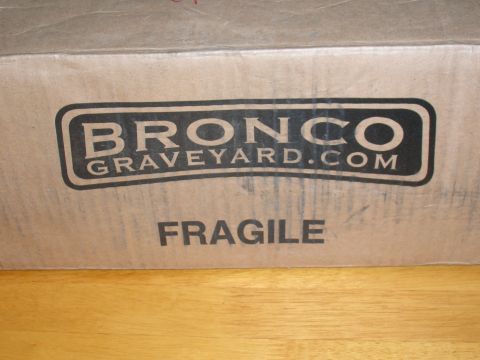 1979 Ford Bronco - A cardboard box from Bronco Graveyard.com is marked "FRAGILE" and sits on a wooden surface.