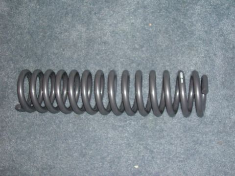 1979 Ford Bronco - A single coil spring is shown against a carpeted background. No vehicle is visible.