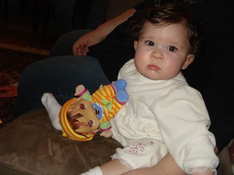 2000 Ford Crown Victoria - Baby sits with a doll, a person's legs are visible behind them.
