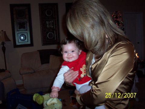 2000 Ford Crown Victoria - A woman holds a baby in a living room setting, with a date stamp of December 25, 2007.