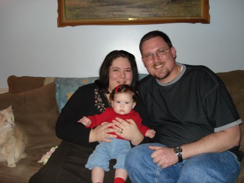 2000 Ford Crown Victoria - A family portrait taken indoors on a couch with a cat sitting nearby.